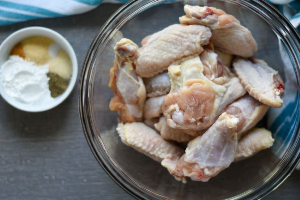 chicken wings and seasonings in separate bowls