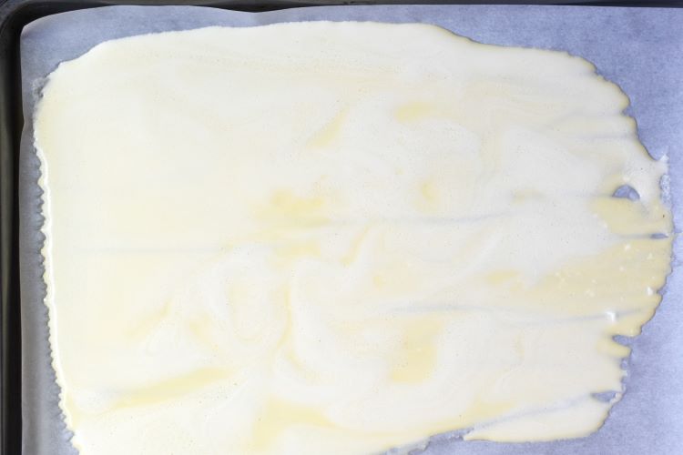 egg mixture spread out on baking sheet
