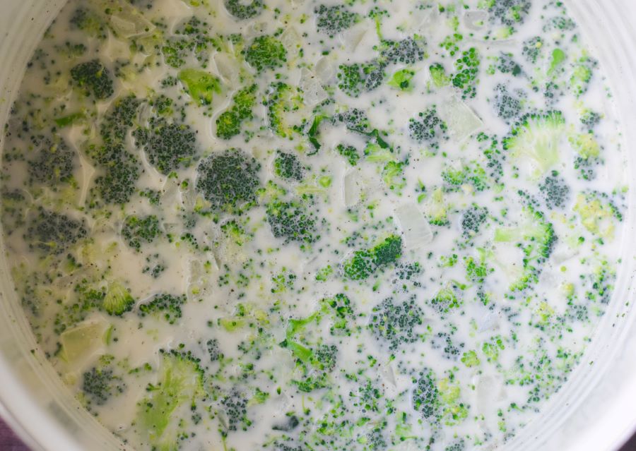 broccoli simmering in heavy cream and chicken broth