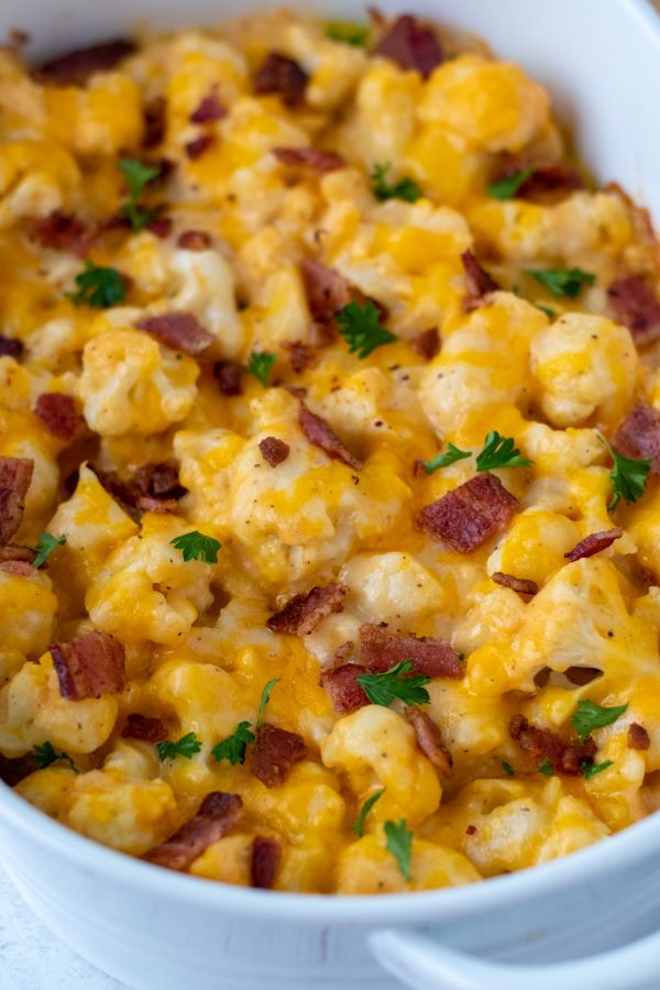 keto cauliflower mac and cheese topped with chopped bacon 