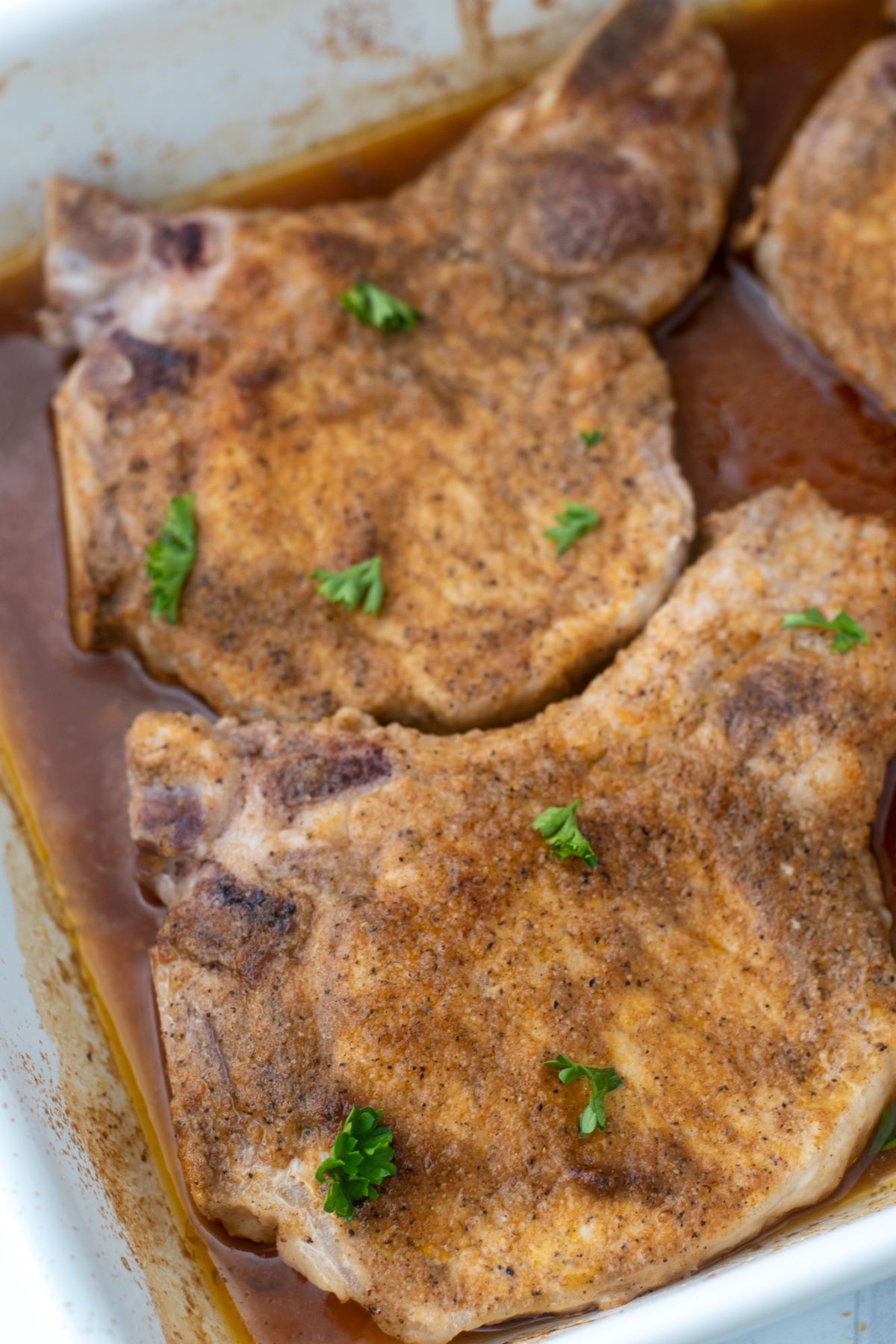 oven baked pork chops in white casserole dish